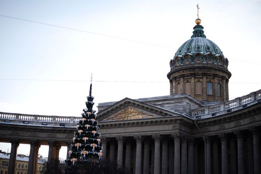 Kazan Cathedral's grand columns and dome with a beautifully decorated Christmas tree in focus.