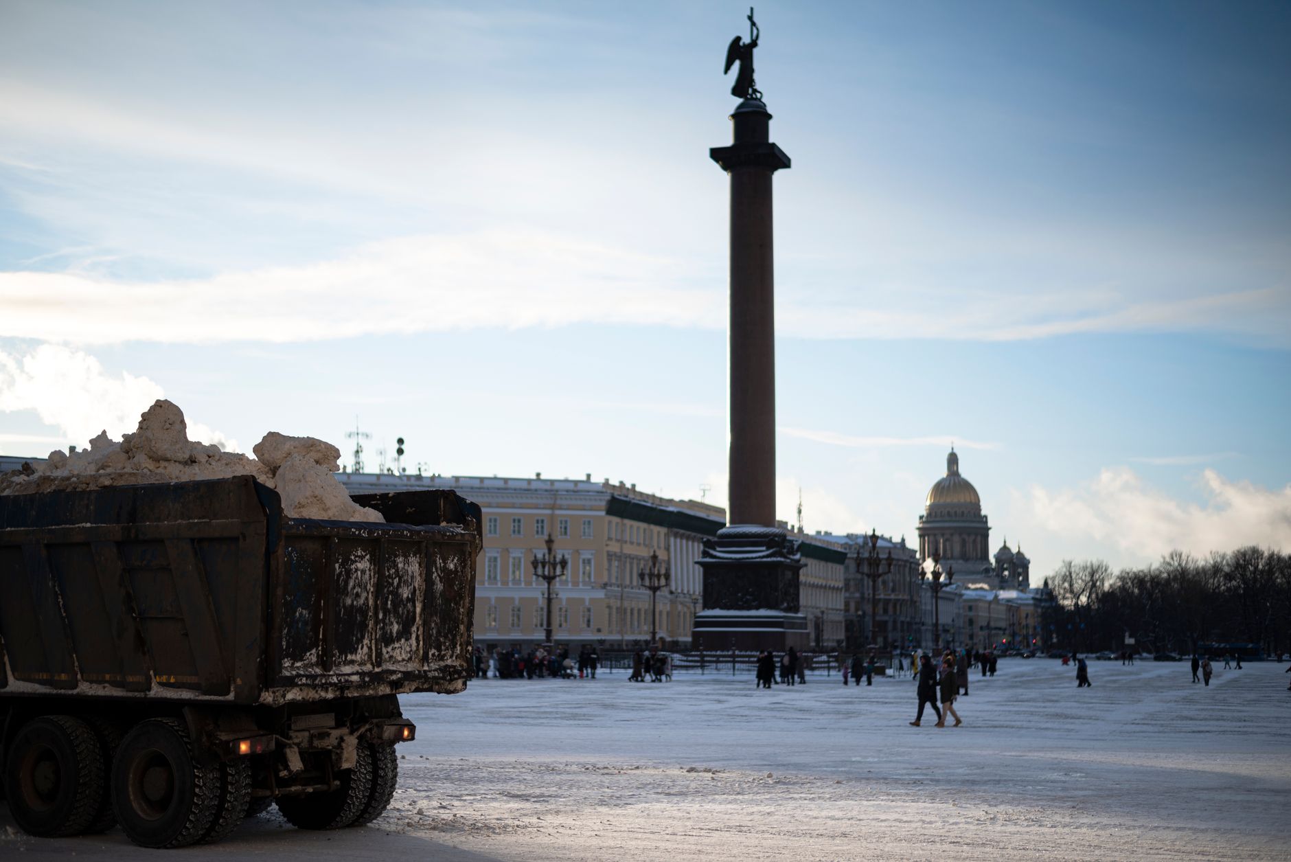 Snow-covered Palace Square in St. Petersburg with Alexander Column and winter landscape.