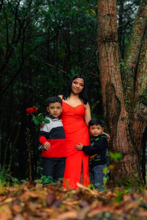 Mother in Red Dress Posing with Sons