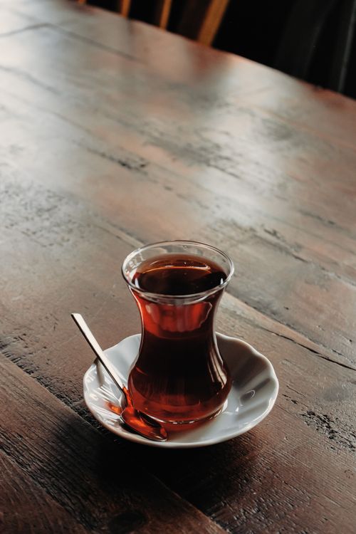 Free A classic glass of tea on a rustic wooden table with natural light. Stock Photo