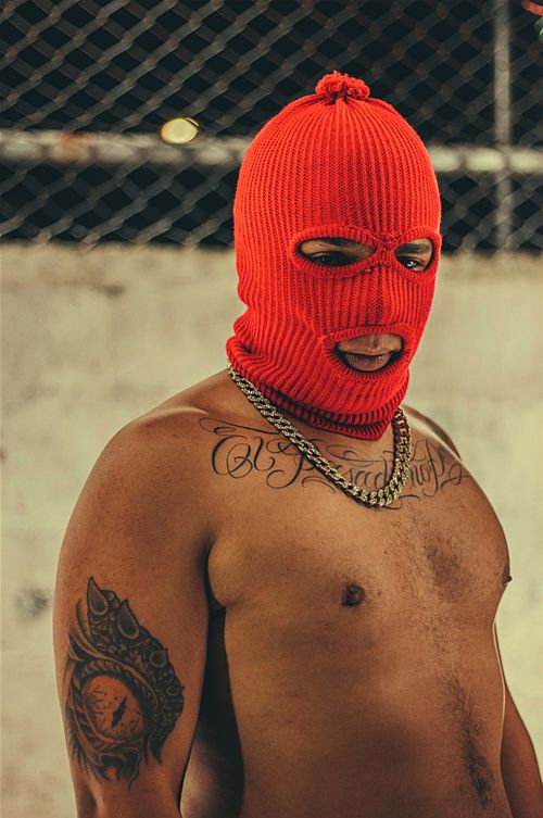 Free A bold street fashion portrait of a man wearing a red mask in Medellín, Colombia. Stock Photo