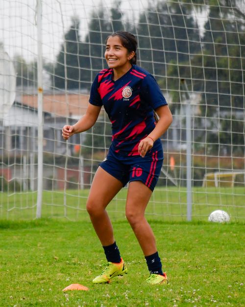 Free A young woman enjoying soccer practice on a bright day. Stock Photo