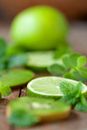 Green Citrus Fruit on Brown Wooden Surface