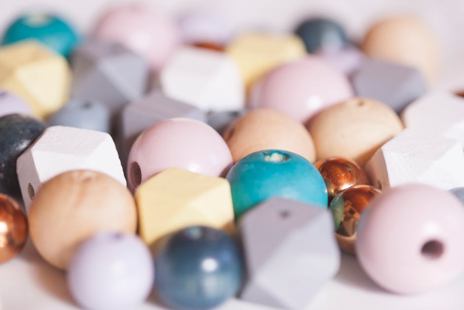Close-up of assorted beads in pastel colors for crafting. Perfect for jewelry making.