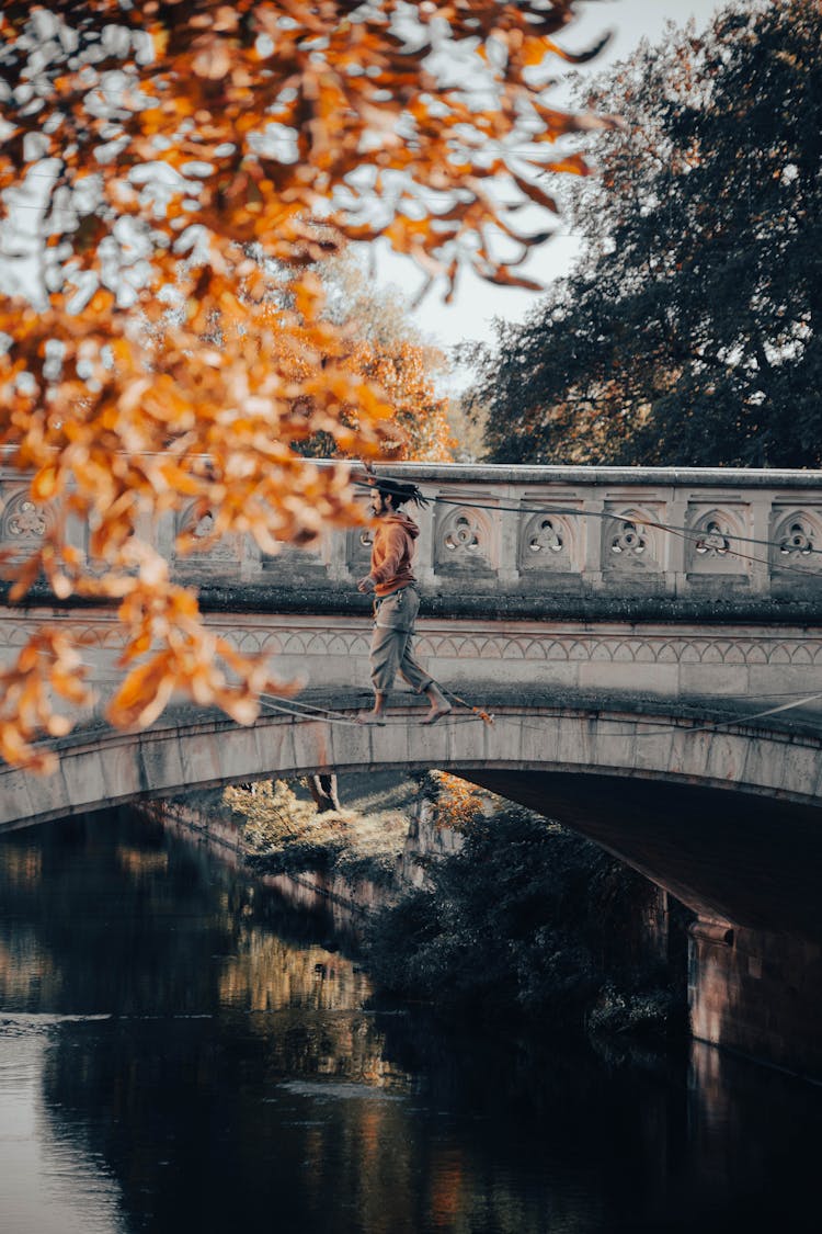 Man Walking On Line Over River