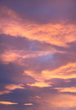 A stunning display of orange clouds at dusk, creating a dramatic sunset scene.