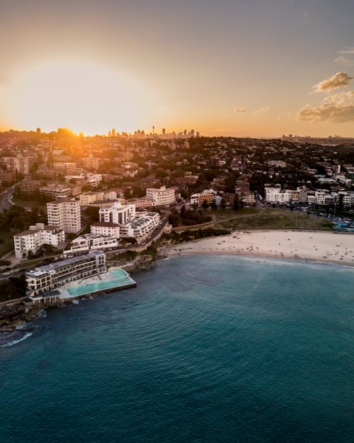 Free Stunning aerial view of Bondi Beach in Sydney at sunset, showcasing the coastline and cityscape. Stock Photo