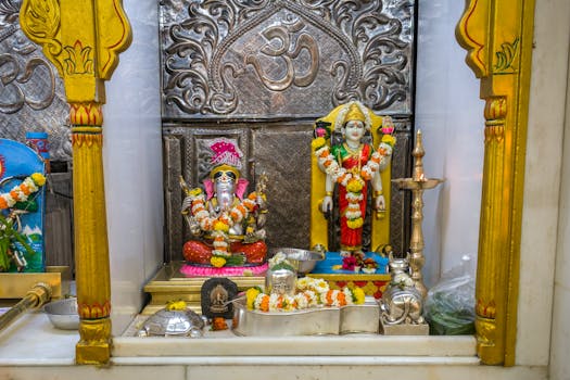 Beautifully decorated Ganesh and Lakshmi idols in a temple showcasing vibrant Hindu cultural festivities.