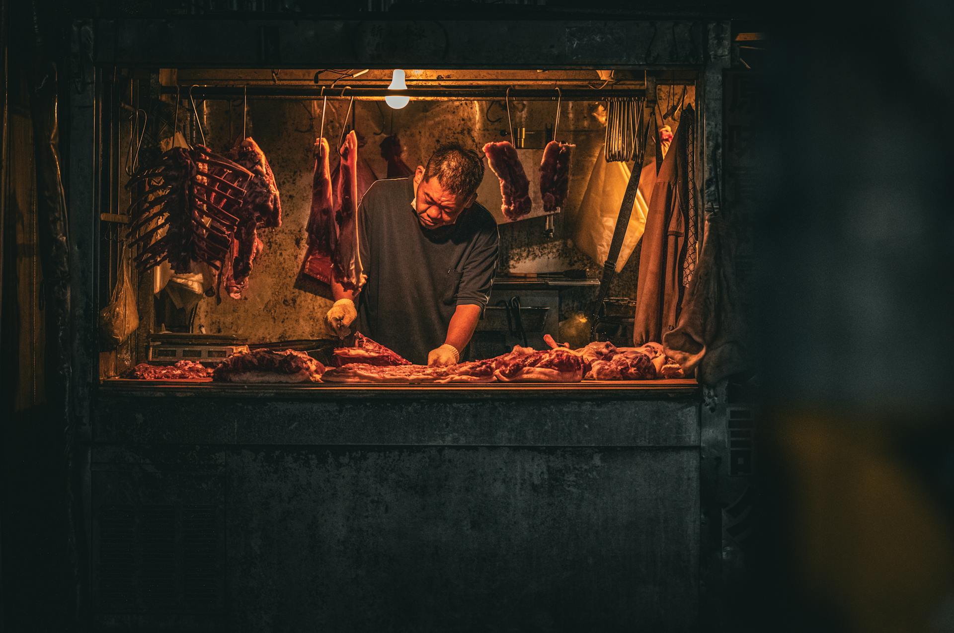 Man Preparing Raw Meat in Market Stall