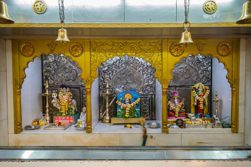 Colorful Hindu temple altar with deity figurines and ornate decorations in Mumbai.