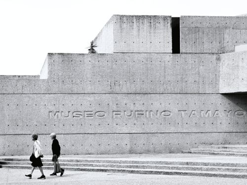 Free Black and white photo of Museo Rufino Tamayo's concrete facade with pedestrians. Stock Photo