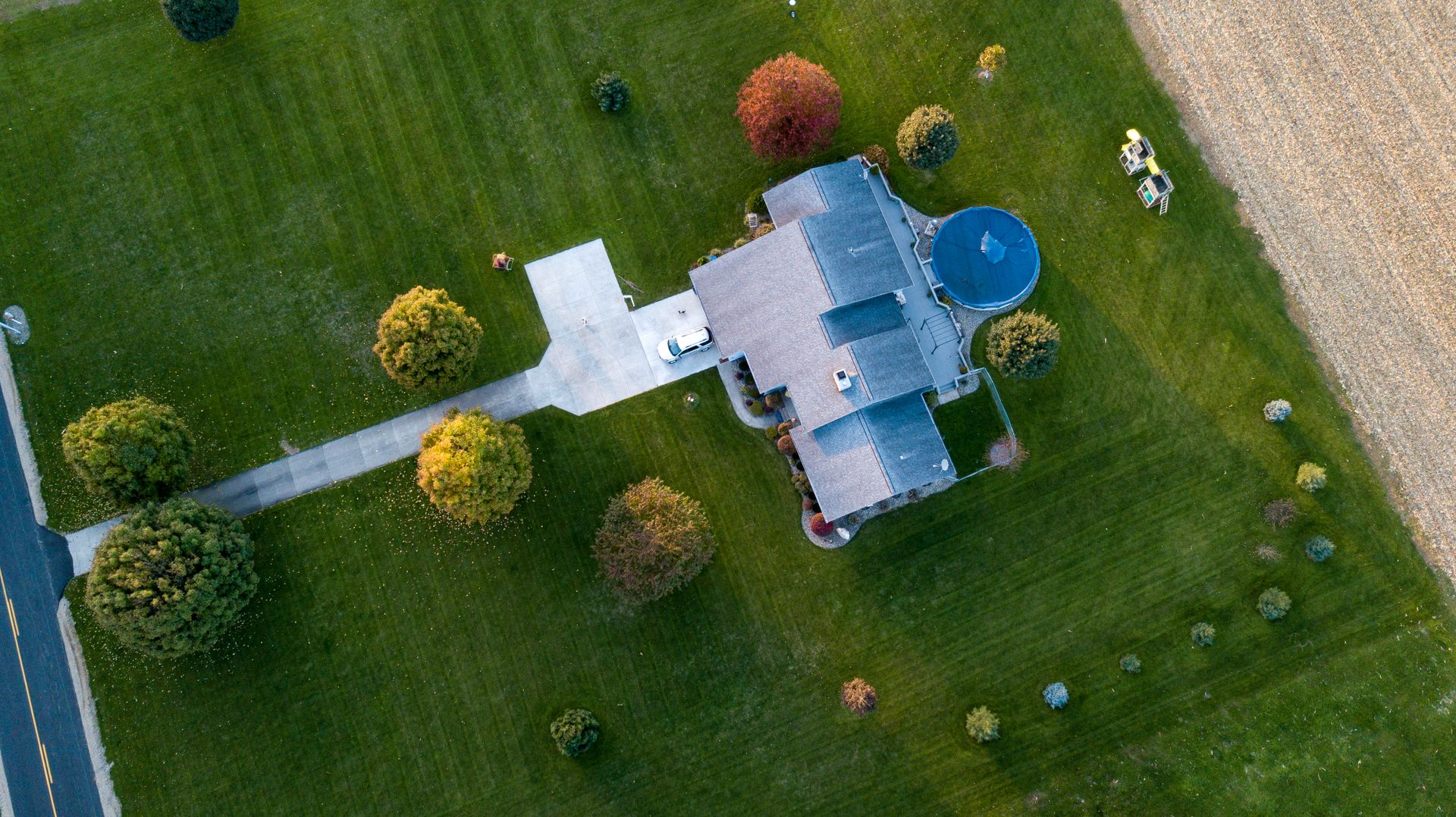 Aerial view of a lush lawn and landscaped property