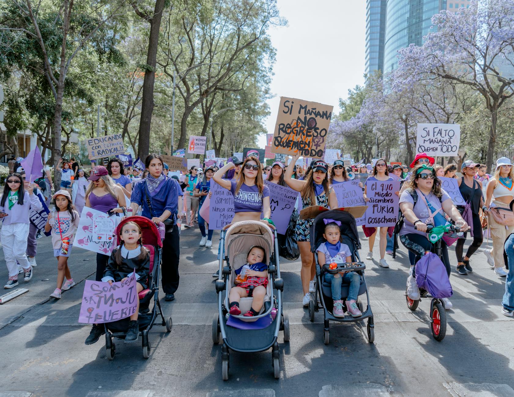 Women and families gather for a Women's Day protest in Mexico City, advocating for empowerment and equality.