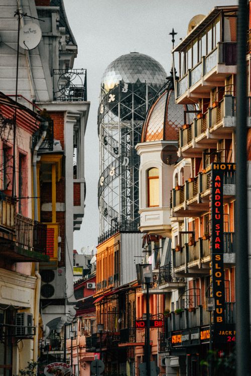 Free Explore the vibrant architecture of Batumi's iconic Alphabet Tower in this urban street view. Stock Photo