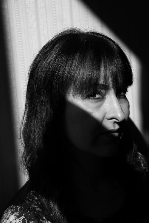 Free Captivating black and white portrait capturing mystery through light and shadow. Stock Photo