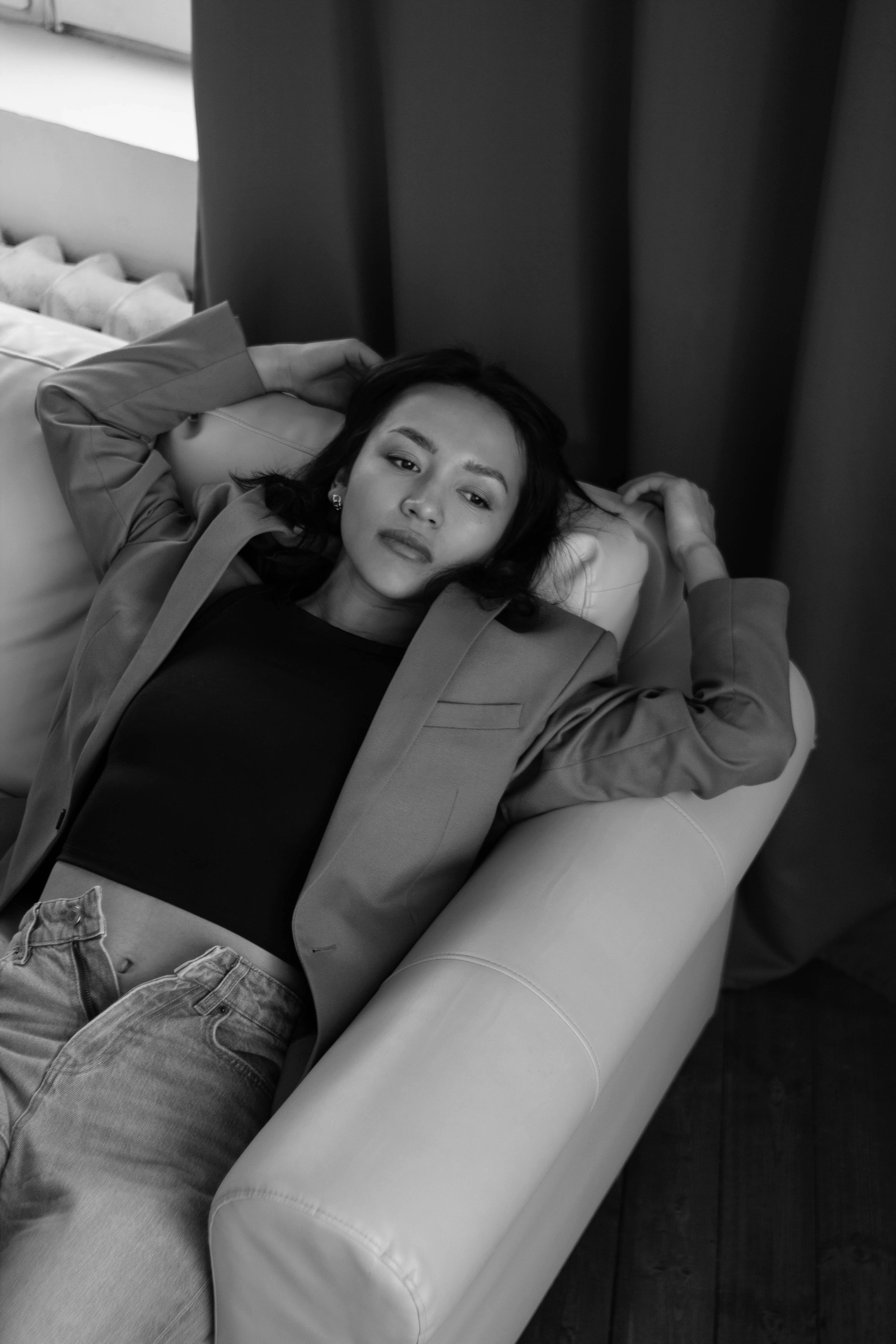 Woman In Denim Overalls Lying On Leather Couch Holding Camera Free woman-in-denim-overalls-lying-on-leather-couch-holding-camera-free
