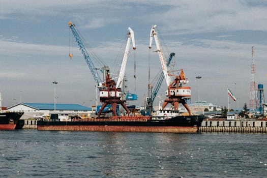 Cargo ships and cranes at the industrial port in Rasht, Gilan Province, Iran.