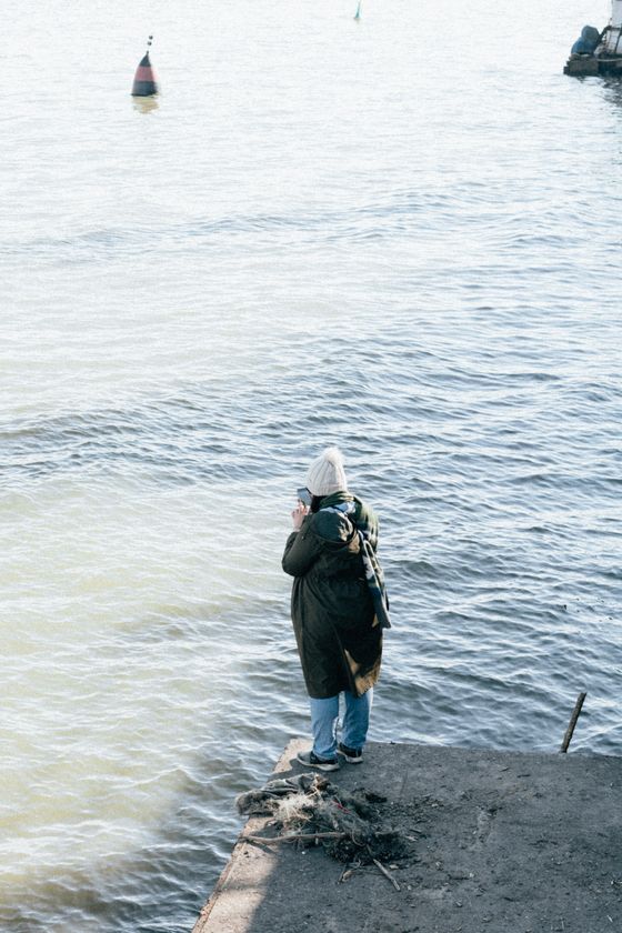 Standing at the end of a pier watching the water — kimiya shabani on Pexels