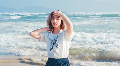 Woman Standing against Waves