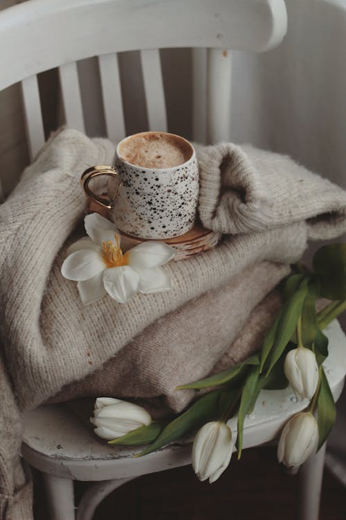 Flowers, Blanket and Coffee Cup on Chair