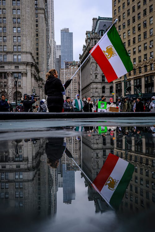 People Protesting with Flag of Iran