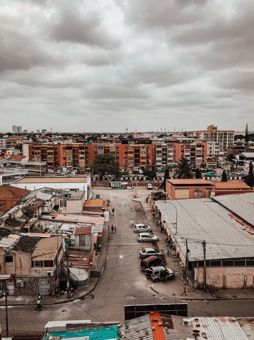 Free Aerial shot of Luanda showcasing urban architecture and infrastructure amidst a cloudy sky. Stock Photo