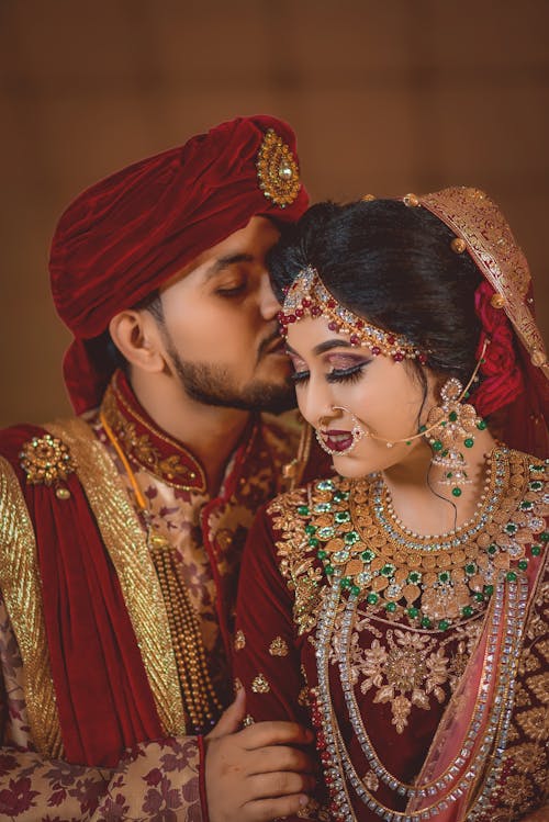 Bride and Groom Wearing Traditional Clothing and Jewelry