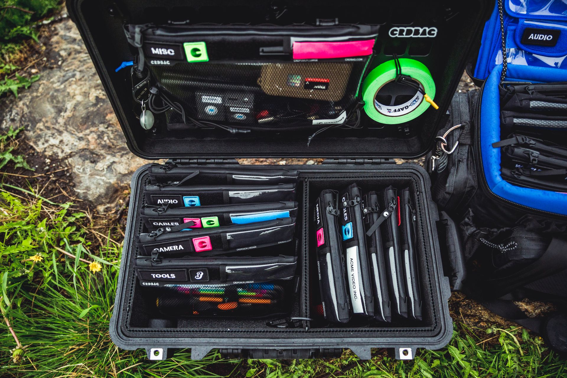 Top view of a well-organized camera equipment case in an outdoor setting.