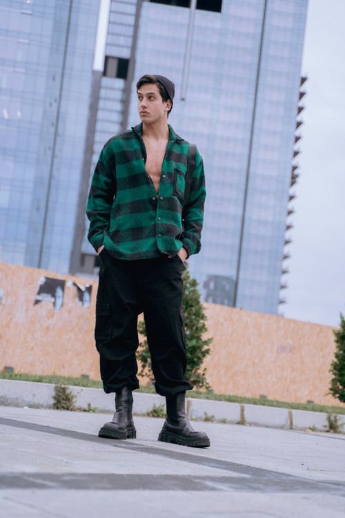 Free A stylish man poses confidently on a city street in İstanbul, surrounded by skyscrapers. Stock Photo