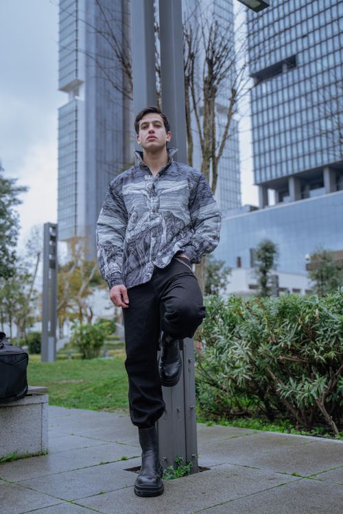 Free Stylish man in a park setting with modern architecture in Istanbul. Stock Photo