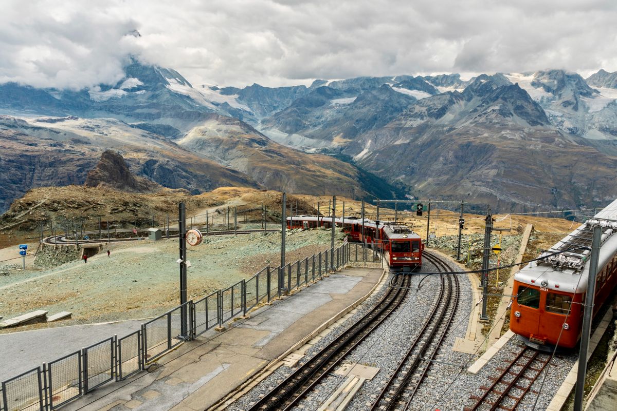 Red Gornergrat cog-railway trains at the mountain station above Zermatt, Switzerland