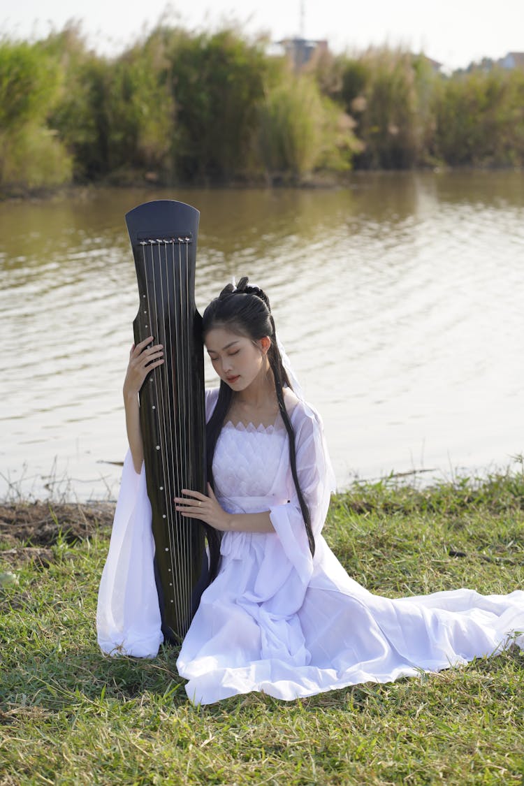 Portrait Of Pensive Bride Near Lake