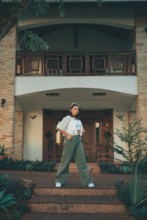 Young Woman in a Trendy Outfit Posing in front of a Building 