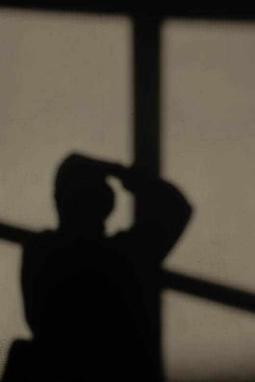 Free Shadow silhouette of a person against a wall, captured in natural light creating an abstract shape. Stock Photo