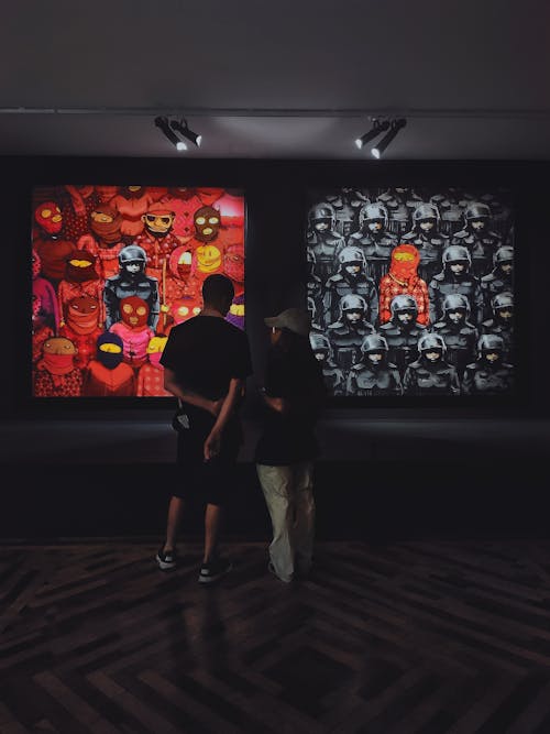 Young Man and Woman Looking at Art in the Gallery