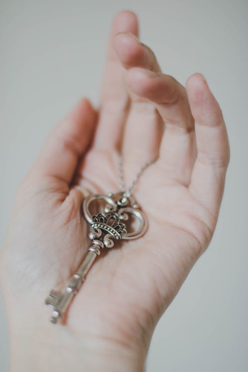 Free Person Holding Silver-colored Skeleton Key Stock Photo