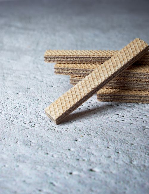 Free Crispy layered waffle sticks arranged on a textured concrete surface. Stock Photo