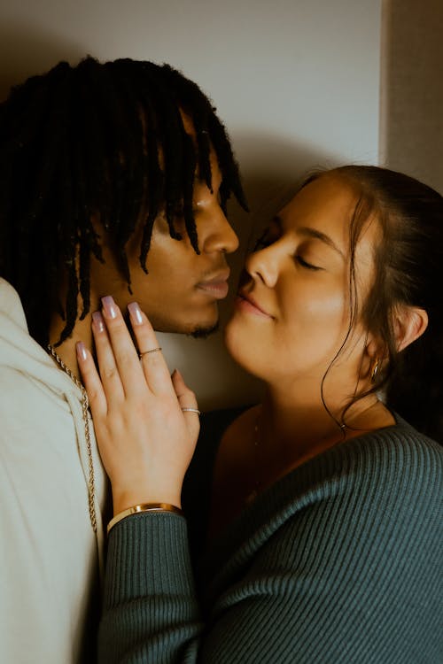 A Young Couple Standing Close and Almost Kissing 