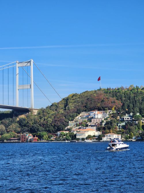 Free A captivating view of the Bosphorus with the Fatih Sultan Mehmet Bridge and colorful Istanbul hillside. Stock Photo