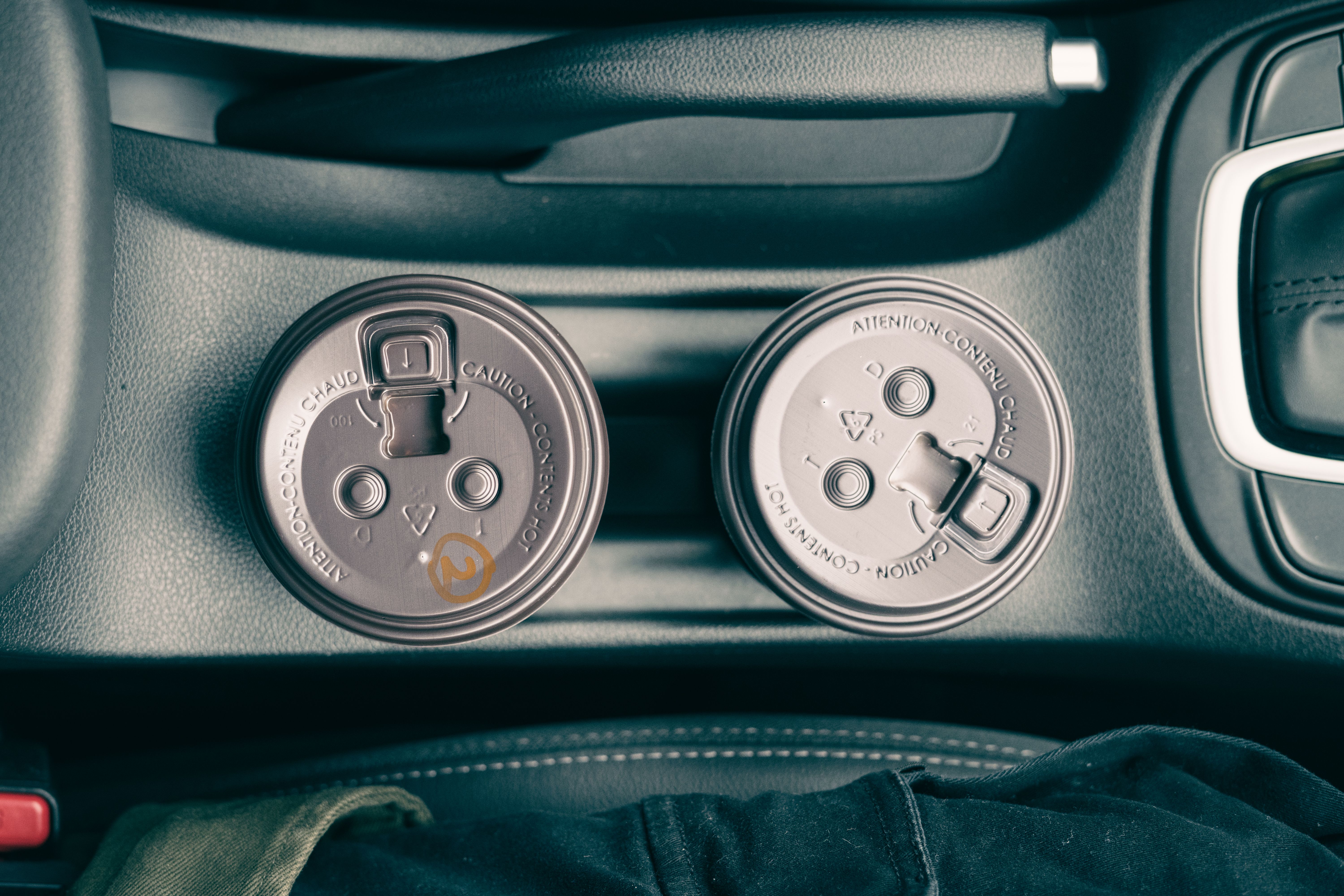 Cups sitting in a car cup holder, viewed from above