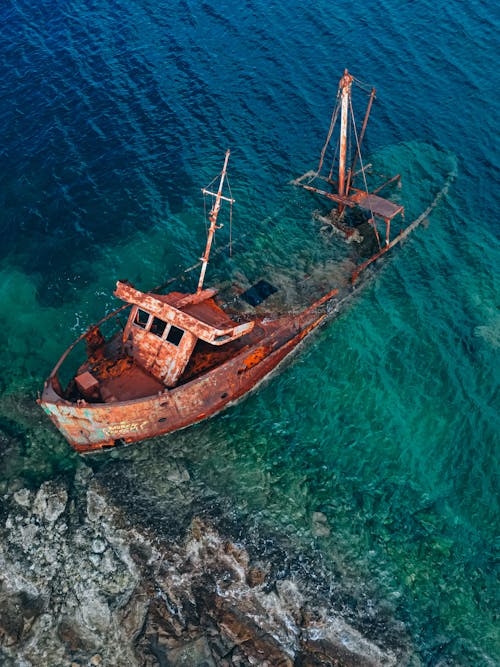 High Angle View of a Rusted Shipwreck in a Turquoise Sea