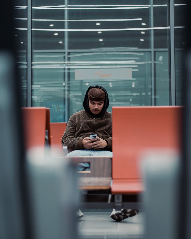 Man Sitting On An Airport 