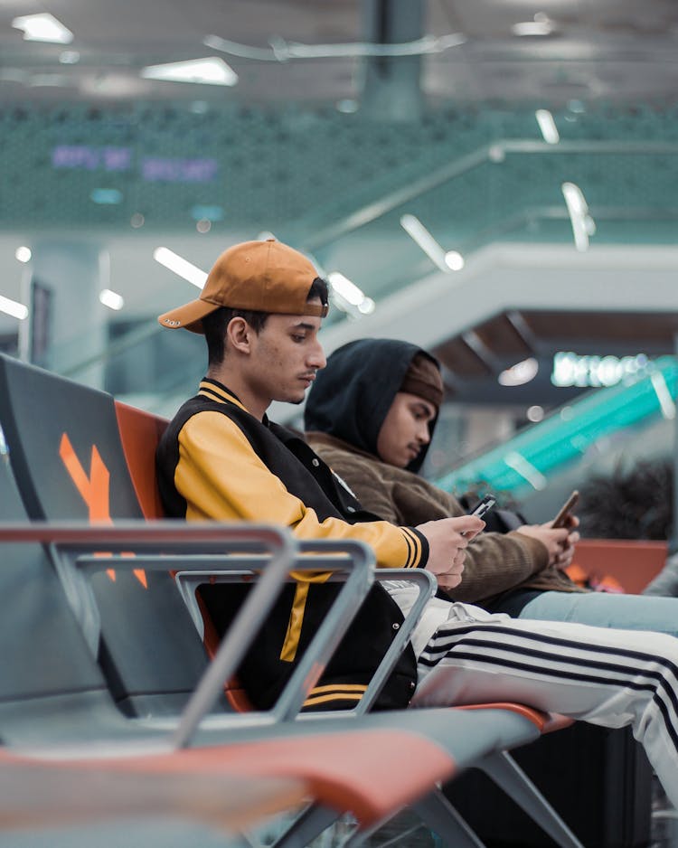 Men Sitting At Airport Terminal