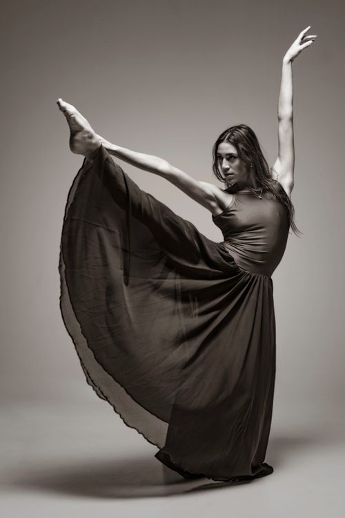 Dancer in a Long Dress Holding Her Leg Up  Free Stock Photo