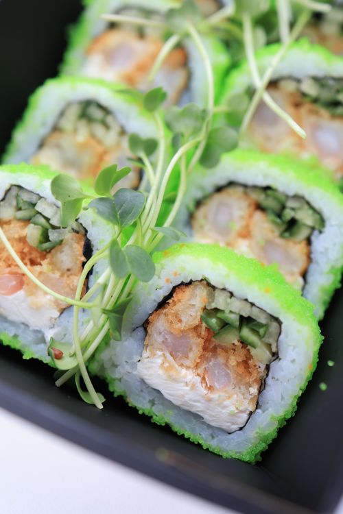 Free Delicious sushi roll garnished with microgreens, showcasing vibrant ingredients. Stock Photo