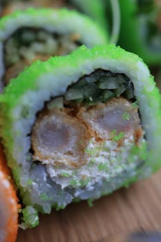 Vibrant sushi roll with green roe and fried filling, perfect for food photography.