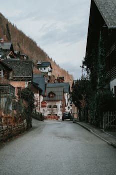 Scenic view of a rustic village street in Hallstatt, Austria, with traditional alpine houses.