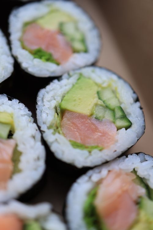 Free Close-up of fresh sushi rolls with salmon, avocado, and cucumber, in detail. Stock Photo