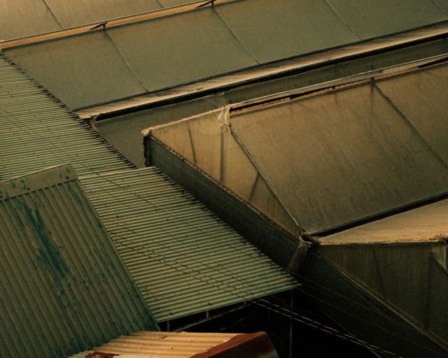 Warehouse roofs from above Aerial view of industrial warehouse rooftops and steel structures