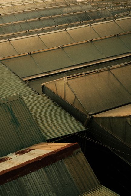 Aerial view of industrial warehouse rooftops with steel structures.